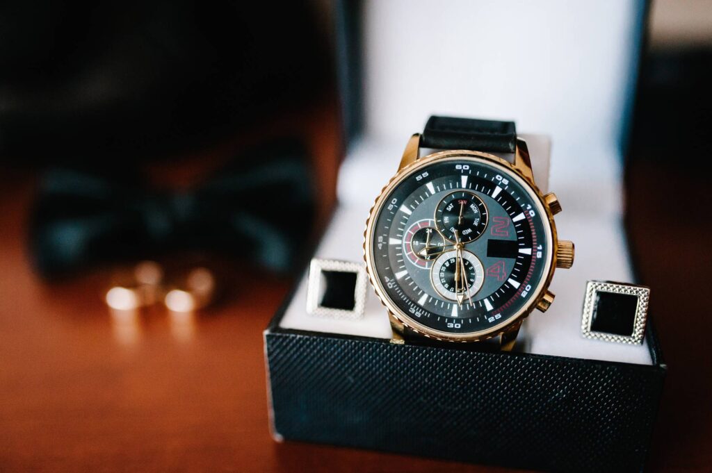 Black watch with three mini dials placed inside a watch box